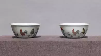 A pair of seemingly identical ceramic bowls featuring painted chickens